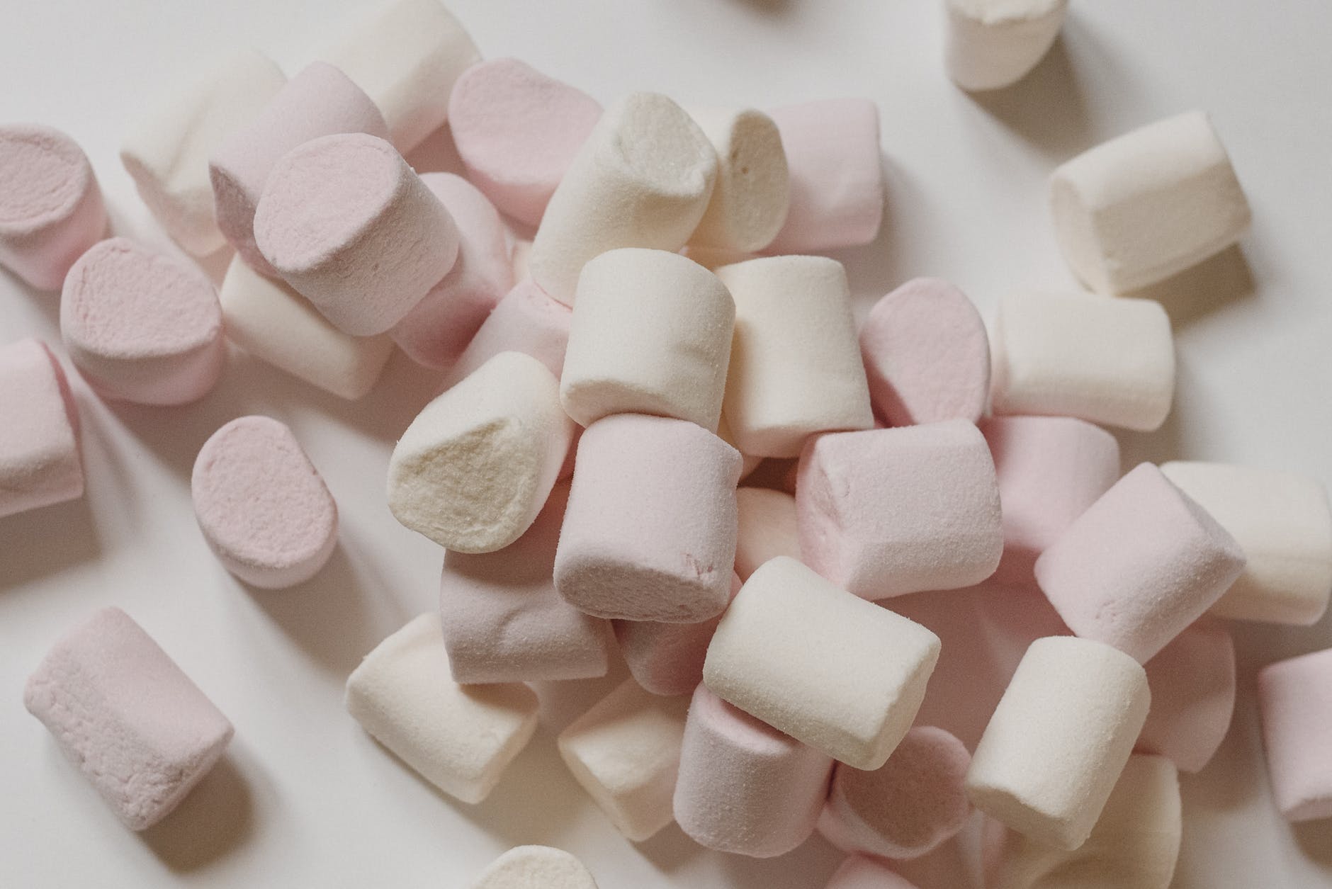 yummy marshmallows heaped on white table